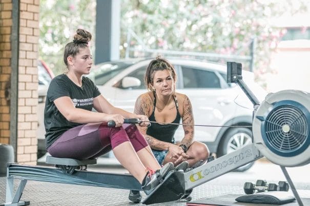 Girl working out on a Rowing machine